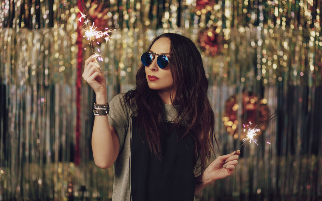 Attractive hipster girl holding sparklers in hands